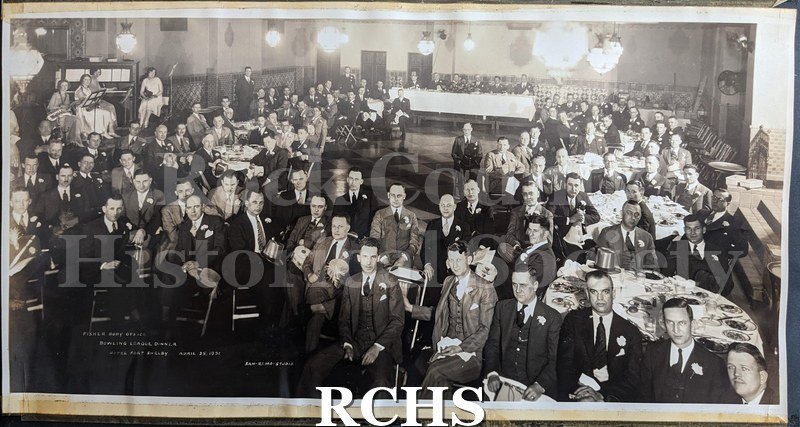 Black and white photograph of the Fisher Body office bowling league dinner, from the Glass photo album. A large group of men are seated around a ballroom.