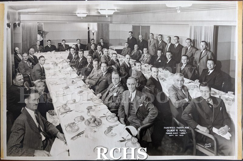 Black and white photograph of men in suits at a farewell party, from the Glass photo album. 45 men are photographed at a farewell dinner party.