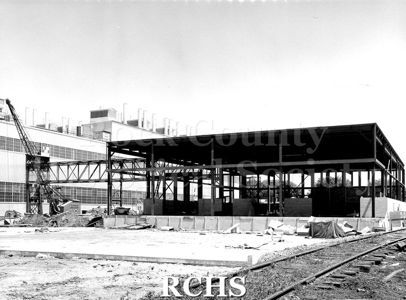 Black and white photograph of the steel outline of the construction. On bottom: "Paint Mix and Storage Building, (Fisher Section) Janesville Plant, Wis.