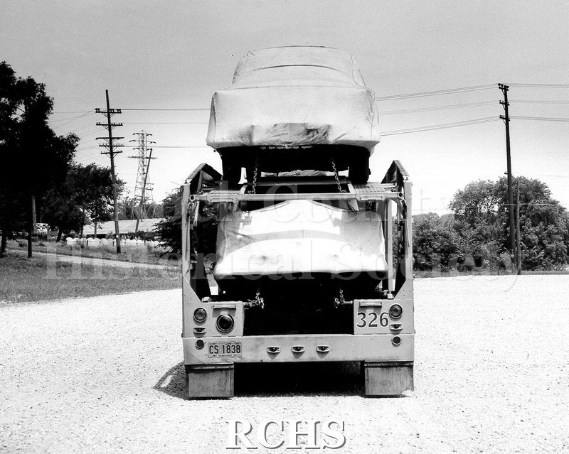 Black and white photograph of a rear view of a loaded low-side W.R. Arthur trailed. All of the cargo units were covered with full Chevrolet car covers.