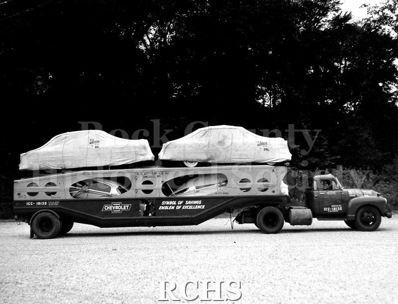 Black and white photograph of a side view of a loaded high-side W.R. Arthur trailer. Lower deck cargo units were covered with standard W.R.