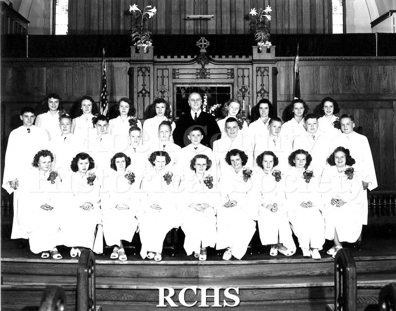 Large black and white group portrait of a confirmation class at an unknown church, likely somewhere in Beloit.