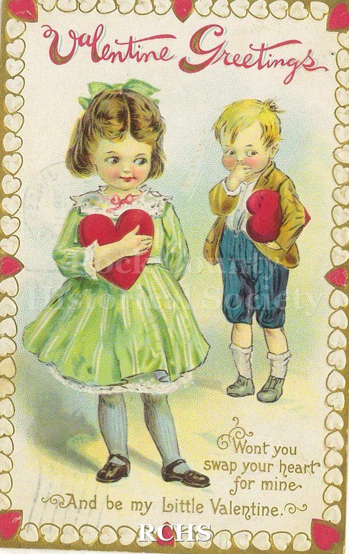 Postcard. Watercolor image of a little girl and boy holding large red hearts and blushing.