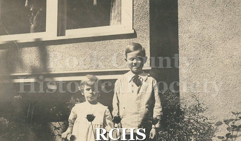 Black and white photograph of Elizabeth & Charles Tallman standing in front of the bay window of the Charles Tallman House.