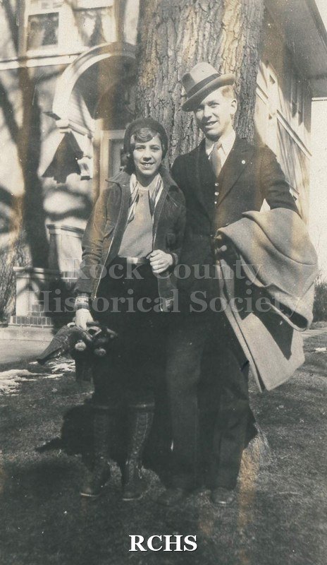 Black and white photograph of Elizabeth and Charles Tallman in front of tree in front of the Charles Tallman House. Shadows on left side.