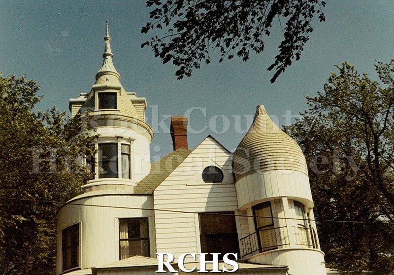Colored photograph of an unidentified house on St. Lawrence Ave. Shows the turret on the left.