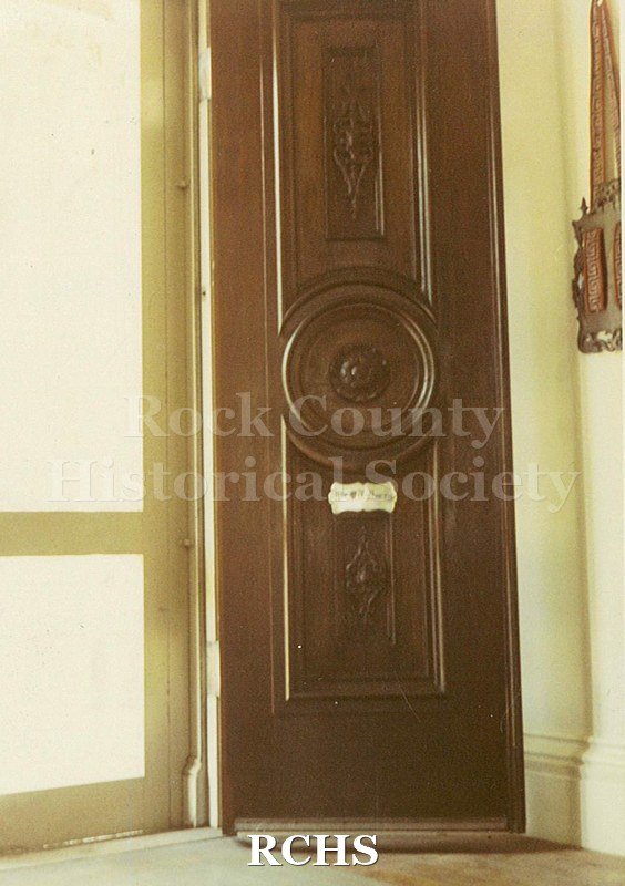 Colored photograph of the front door in the Tallman House.