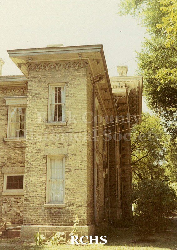 Colored photograph of part of the Tallman House. Shows wires into the house.