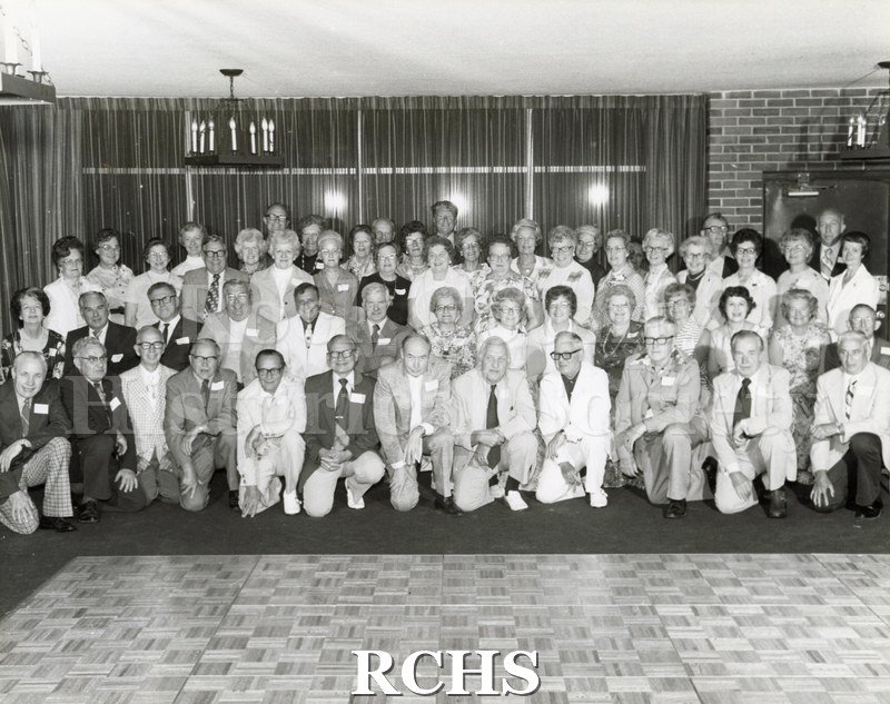 Black and white photograph of the Janesville High School Class of 1932 at their 45th Reunion. The event was held on 211 June 1977 at the Holiday Inn.