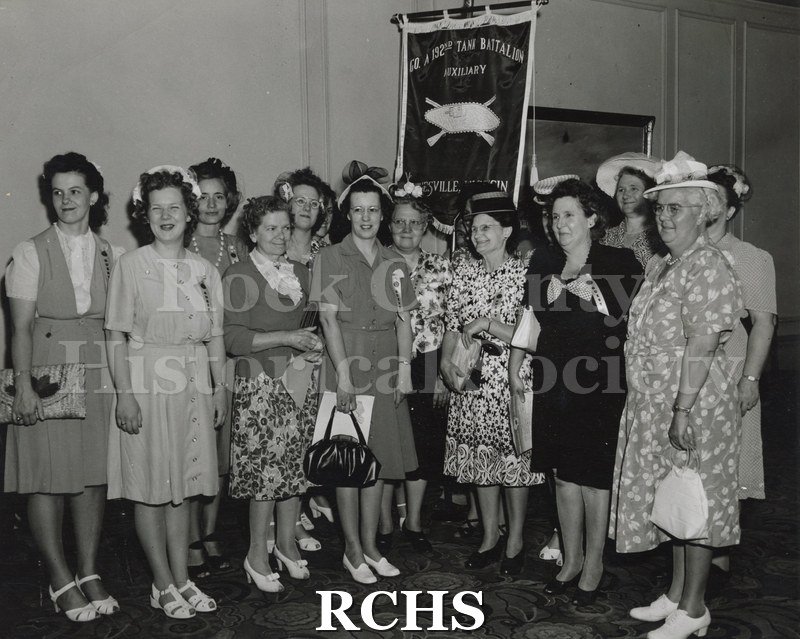 Black and white photograph of female relatives of the "Janesville Tanks" survivors beofre the welcome home parade in Milwaukee.