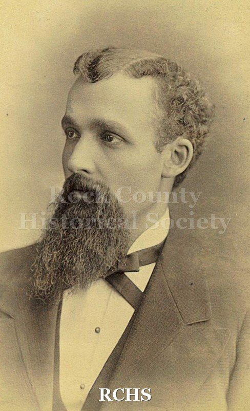 Black and white photograph of Charles S. Felton, 1878. He is father to May Felton Tallman. Hair is side parted and curly on sides. Full beard and moustache.
