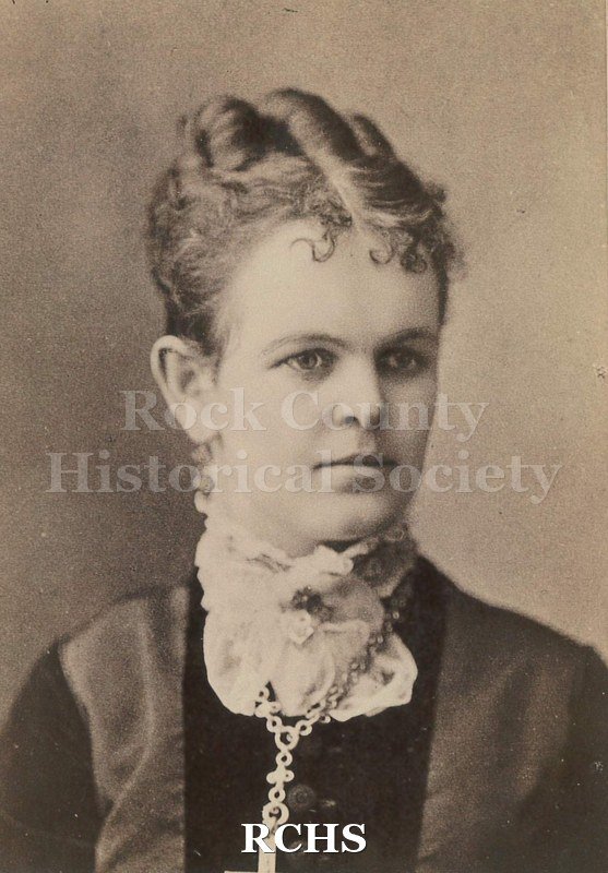 Black and white photograph of Clara LaClaire Palmer Felton. She is mother to May Felton Tallman. Hair is side parted, pulled back with small spitcurl bangs.