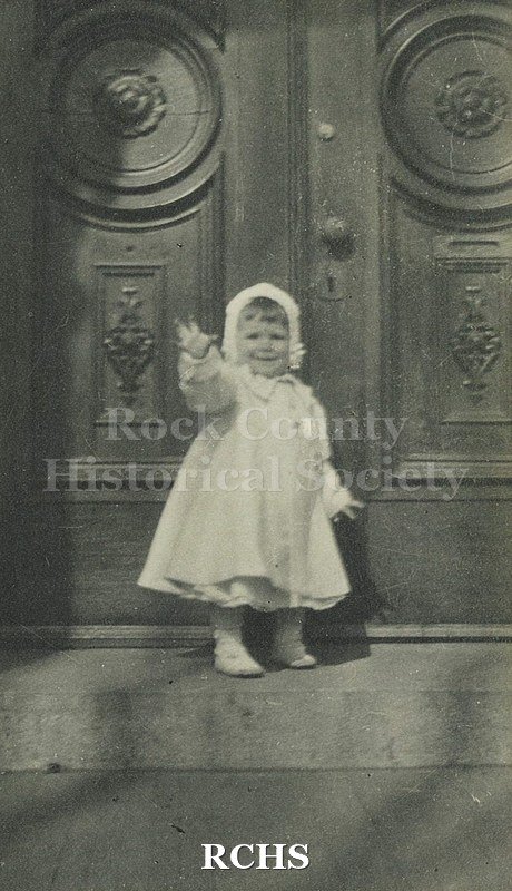 Black and white photograph of Elizabeth C. Tallman as toddler, dressed in coat and hat.