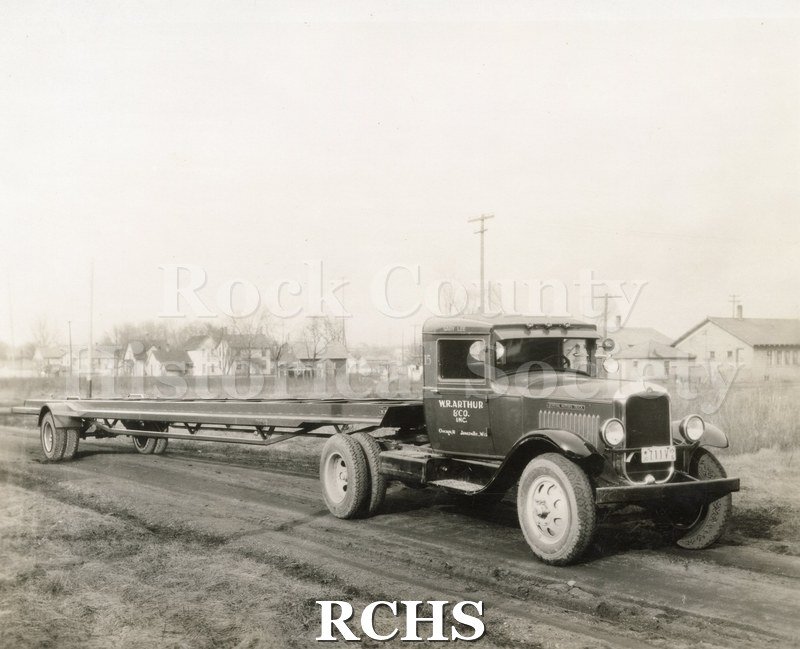 Black and white photograph of an empty W.R. Arthur transport truck. Side door is marked Chicago and Janesville.