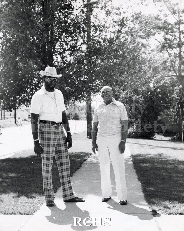 Black and white photograph of Dr. Benjamin L. Hooks and Thomas E. White standing on a sidewalk.