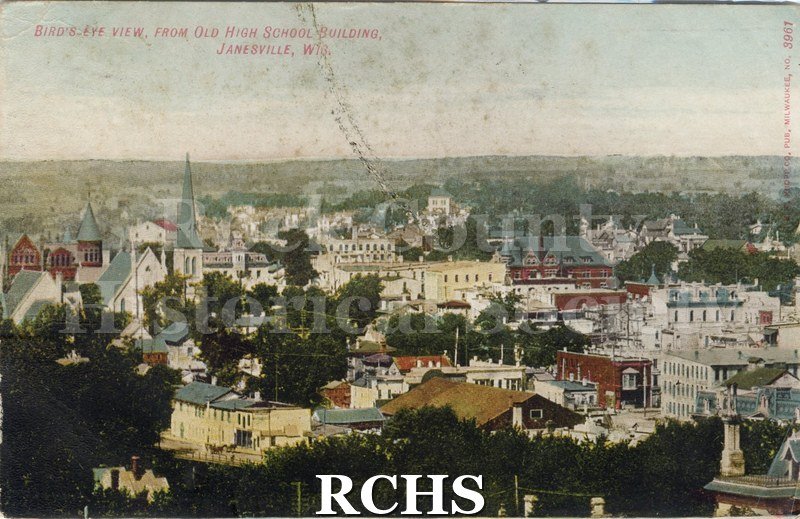 Postcard. tinted photo of an aerial view of Janesville from the Old High School building. Postmarked from Janesville on 15 September 1908.