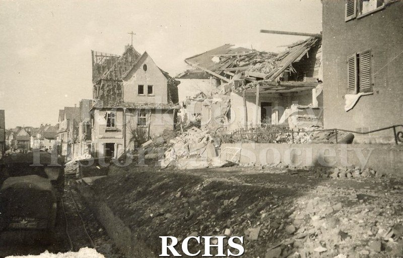 Black and white photograph of war damaged homes. Back of photo reads: "12).