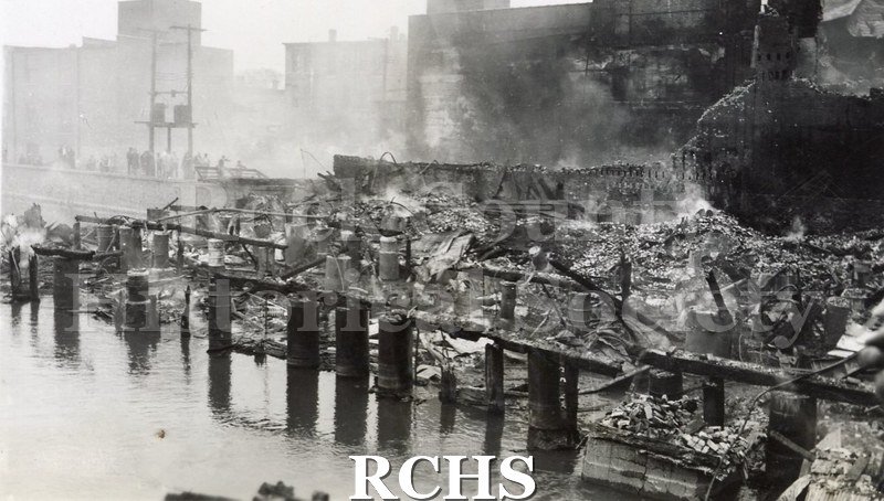 Black and white photograph of the aftermath of a large fire on Milwaukee Street in downtown Janesville.