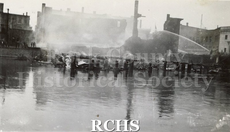 Black and white photograph of the aftermath of a large fire on Milwaukee Street in downtown Janesville.