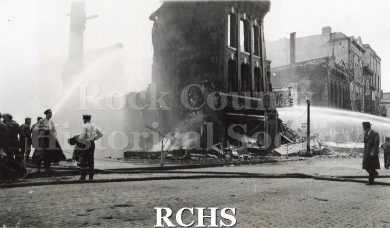 Black and white photograph of the aftermath of a large fire on Milwaukee Street in downtown Janesville.
