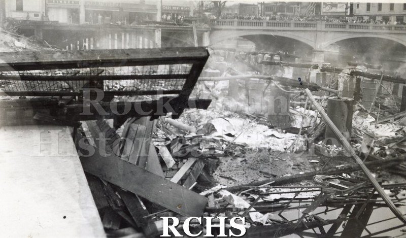 Black and white photograph of the aftermath of a large fire on Milwaukee Street in downtown Janesville.