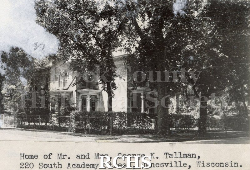 Black and white photograph of 220 S. Academy St., Janesville, WI, a brick two story house shown from the side. On bottom: "Home of Mr. and Mrs. George K.