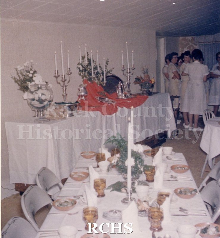 Color photo of a banquet table set with floral arrangements and candelabra.