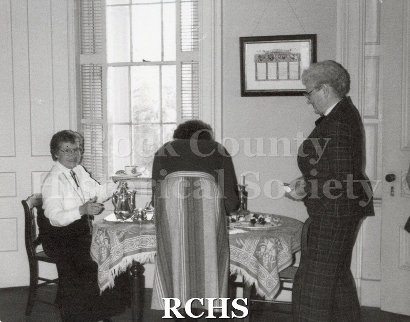 Black and white photograph of three women at a tea.