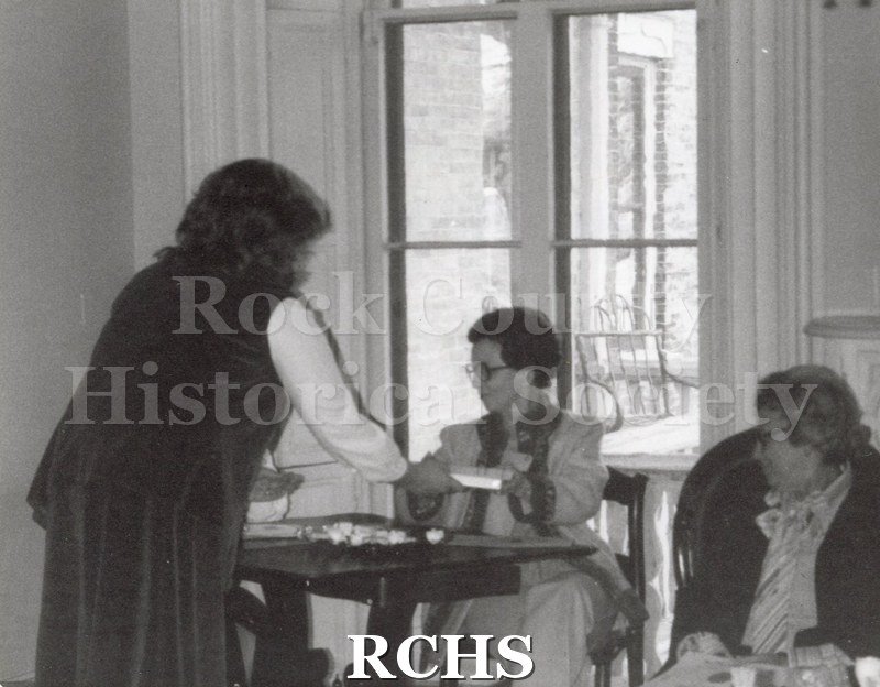 Black and white photograph of three women at a tea.