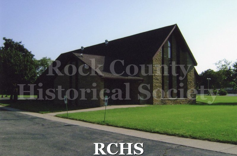 Colored photograph of Family Worship Center, Assembly of God, 2021 Cranston Rd., Beloit. Light color limestone with dark brown trim.