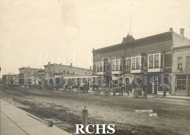 Black and white photograph of a street with horse and buggies, Clinton northend.