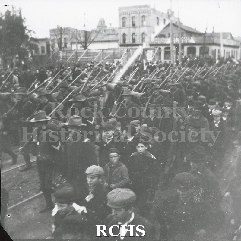Black and white photograph of soldiers from Company I, First Regiment, who served in the Spanish-American War, marching in a Janesville parade.