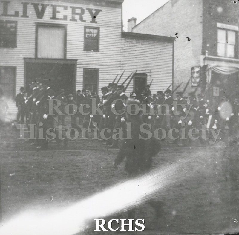 Black and white photograph of soldiers from Company I, First Regiment, who served in the Spanish-American War, marching in a Janesville parade.