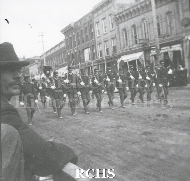 Black and white photograph of soldiers from Company I, First Regiment, who served in the Spanish-American War, marching in a Janesville parade.
