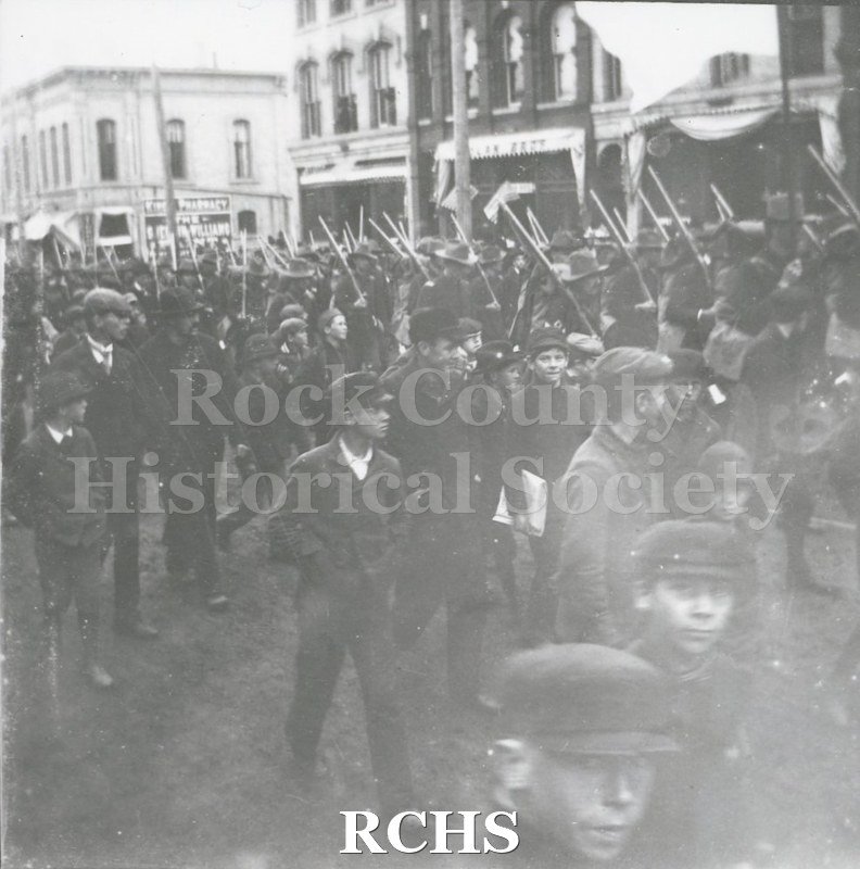 Black and white photograph of soldiers from Company I, First Regiment, who served in the Spanish-American War, marching in a Janesville parade.