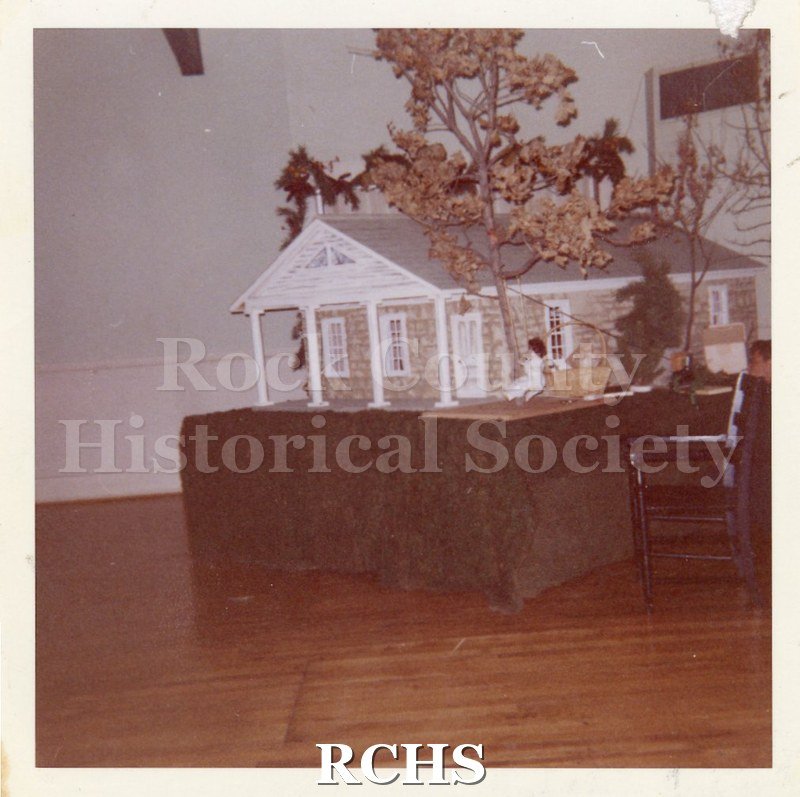 Color photo of a scale model of the Stone House set on a table.