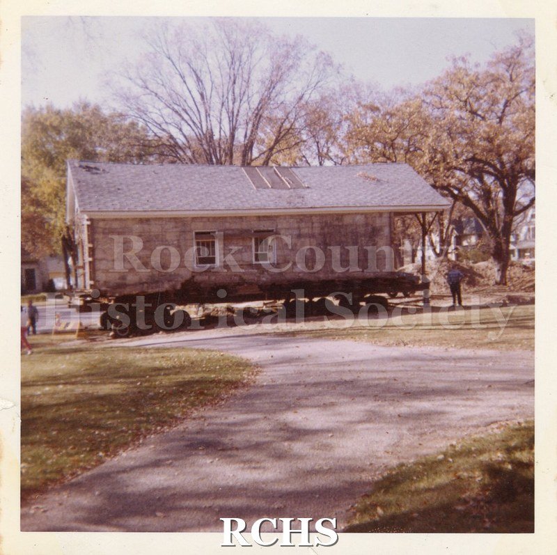 Color photo of the Stone House on skids at the Tallman Restorations.