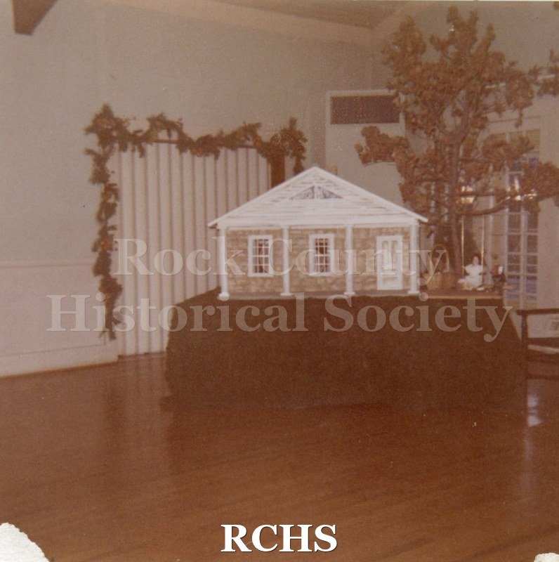 Color photo of a scale model of the Stone House set on a table.