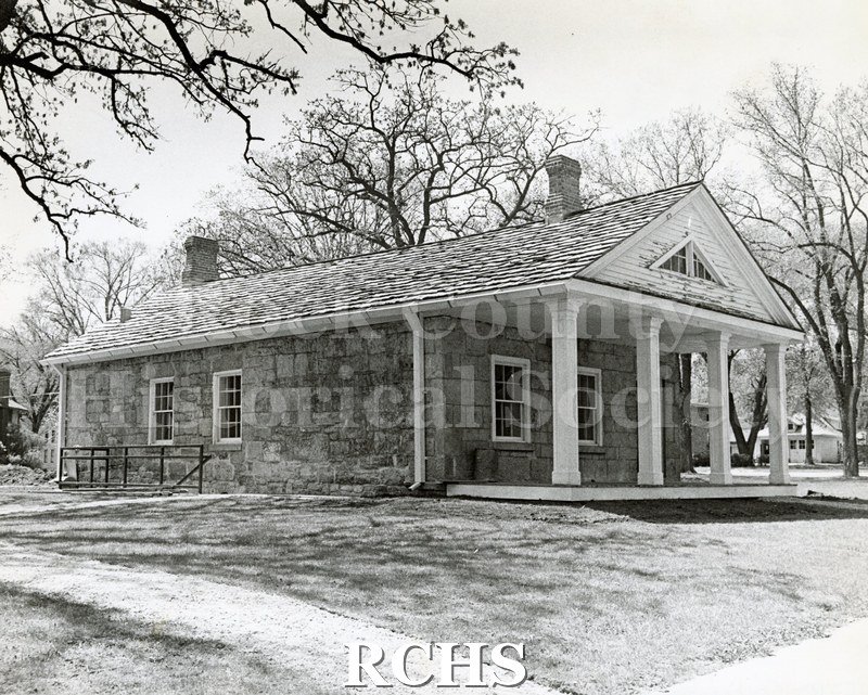 Black and white photograph of the Stone House without any shrubbery.