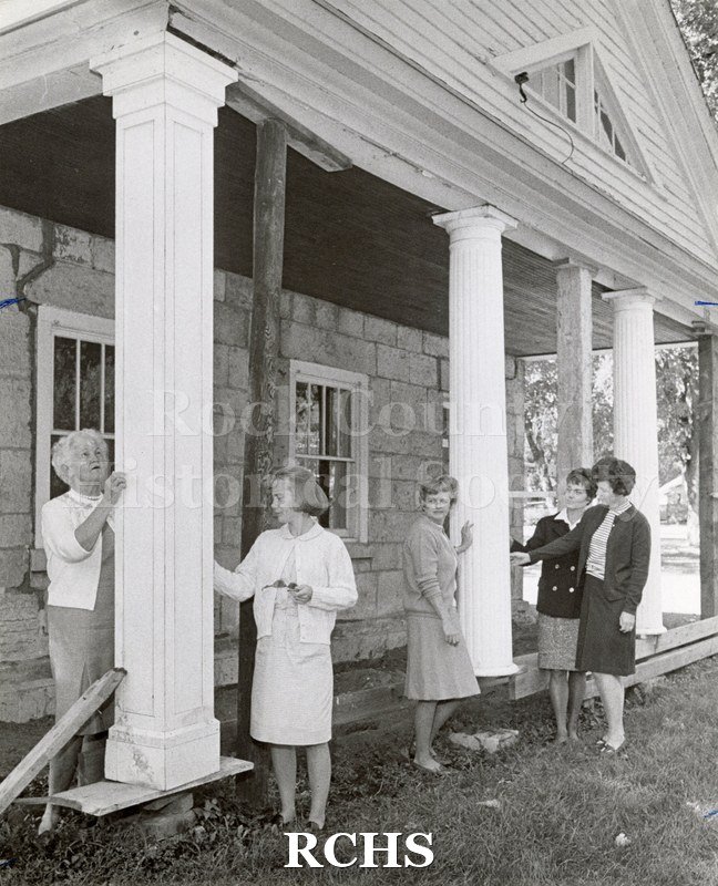 Photo. Black and white photograph of five women standing in front of the Stone House.