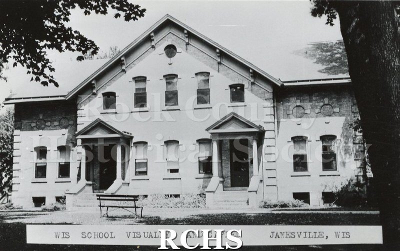 Black and white photograph of Wisconsin School for the Visually Handicapped. Shows a large building with trees in front.