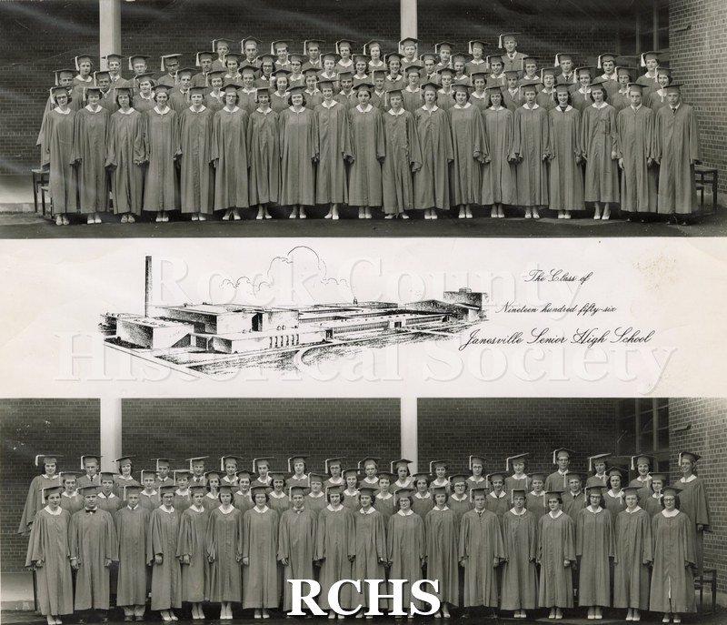 Black and white photograph of Janesville Senior High School 1956. Shows men and women in graduation gowns and caps standing in front of brick building with white.