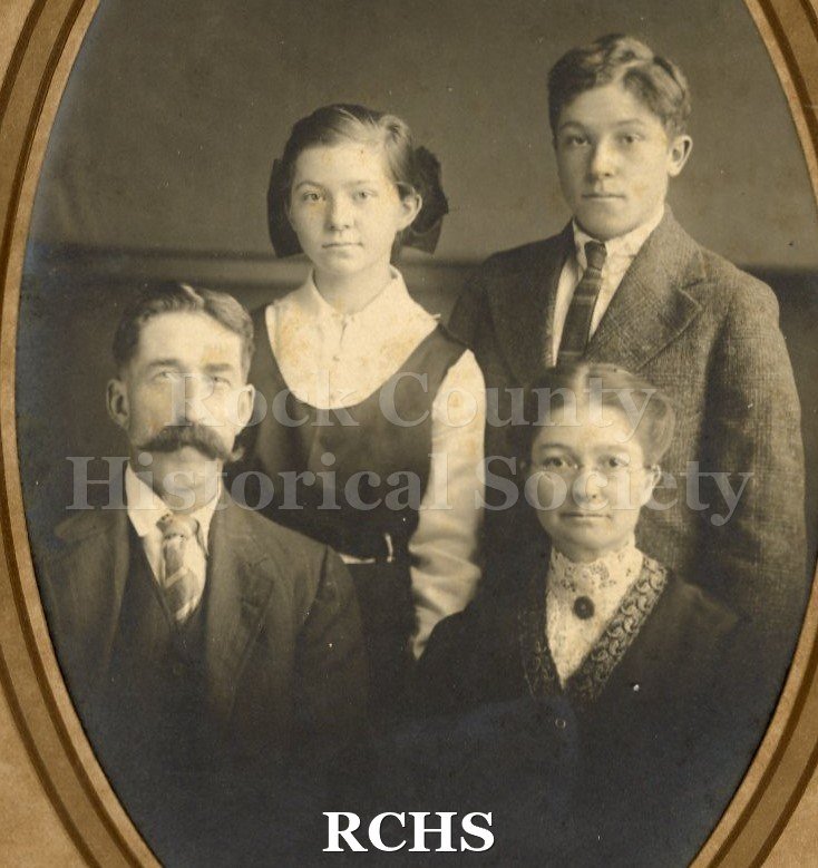 Black and white photograph of Ernest E. and Fanny Haylock with their children John and Eva. The man is seated and the woman is standing by the girl and boy.