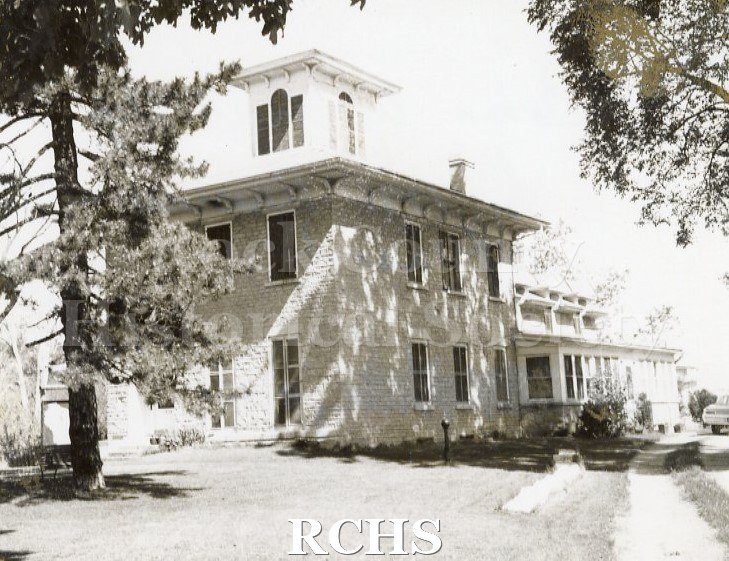 Black and white photograph of Bartlett House, a two story brick house with a cupola on top.