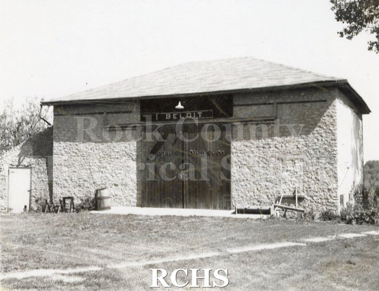 Black and white photograph of the Bartlett Museum Barn, Beloit, WI, a brick barn with double doors. Above the doors is "Beloit".