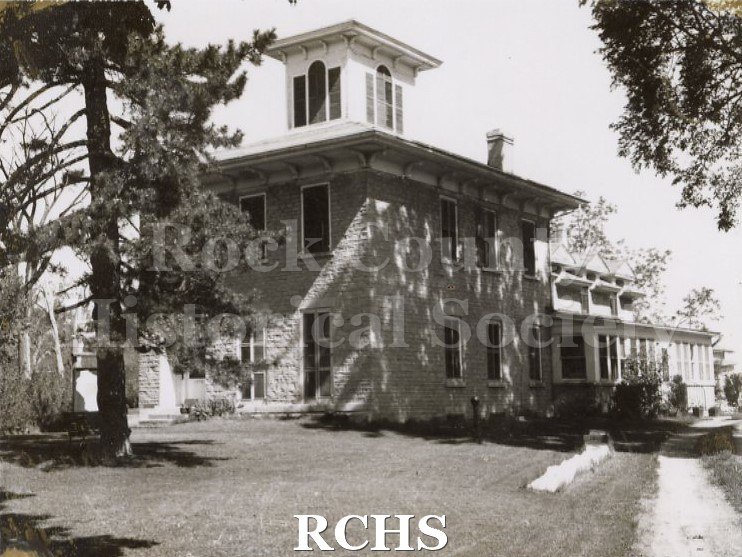 Black and white photograph of Bartlett House, Beloit, WI, a two story brick house with a cupola on top.