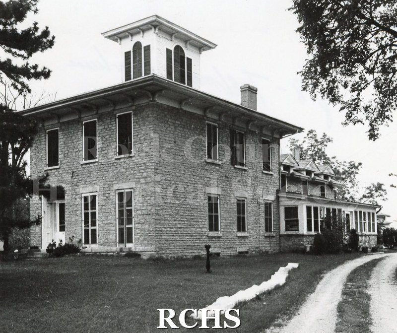 Black and white photograph of Bartlett House, a two story brick building with a square cupola on top.