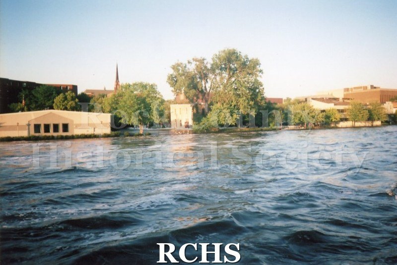 Color photo of the Rock River during the 2008 flood in Janesville. Looking toward east side of Rock River, showing the United Way building and St. Mary's.