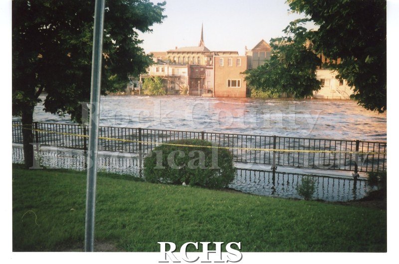 Color photo of the Rock River flooding during the June 2008 flood in Janesville. View from the west bank of the river looking east towards St.
