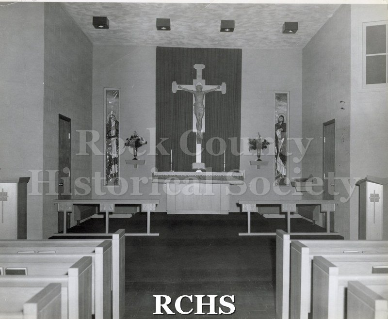 Black and white photograph of the interior of Holy Trinity Lutheran Church, Albion, PA, looking toward the altar.